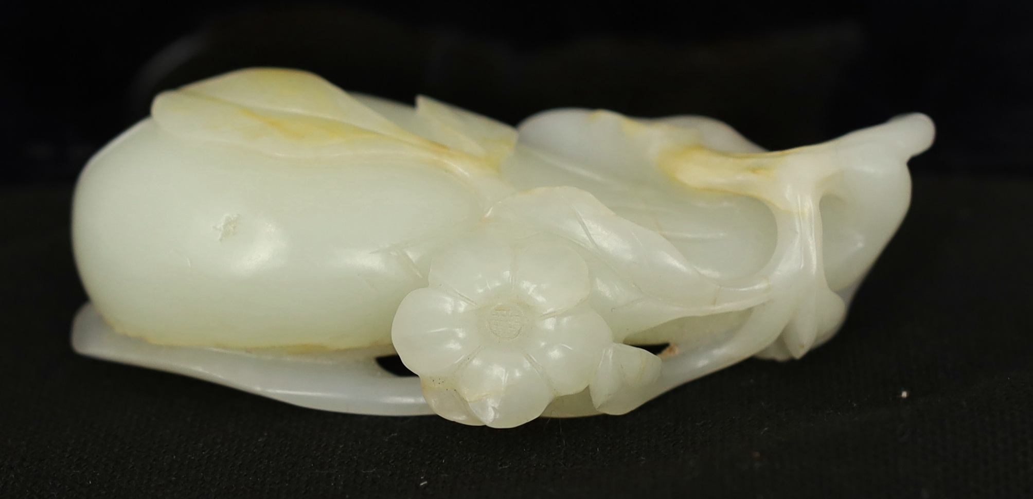 A Chinese pale celadon jade carving of a fruit, 18th century